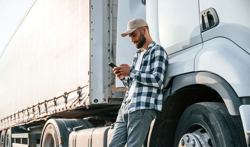 trucker outside of truck on phone